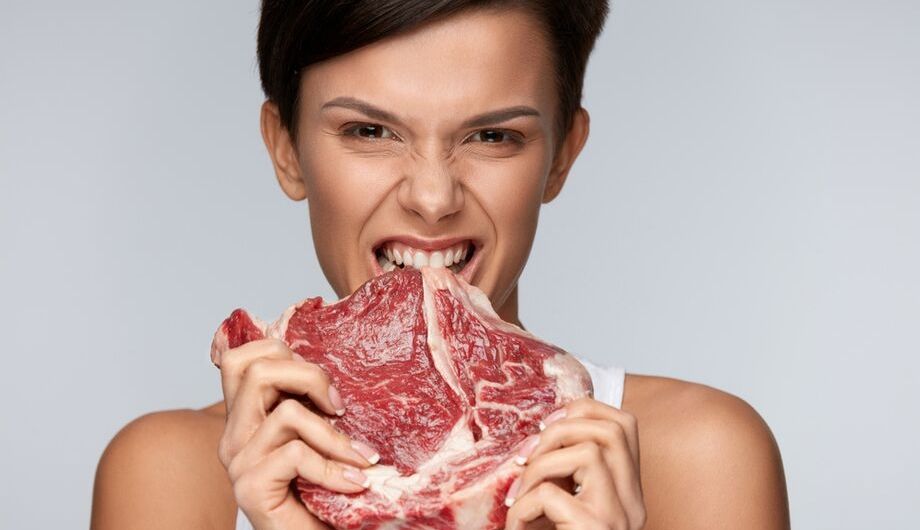 woman biting into raw meat